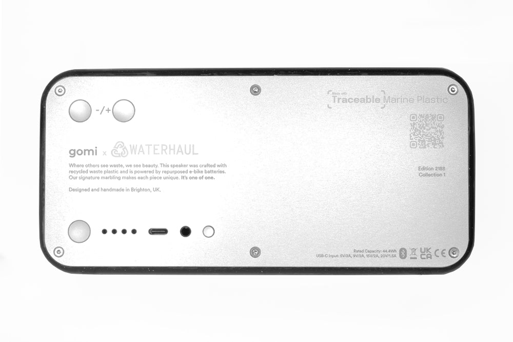 Back view of a speaker device with gomi and waterhaul branding and technical details on a white background