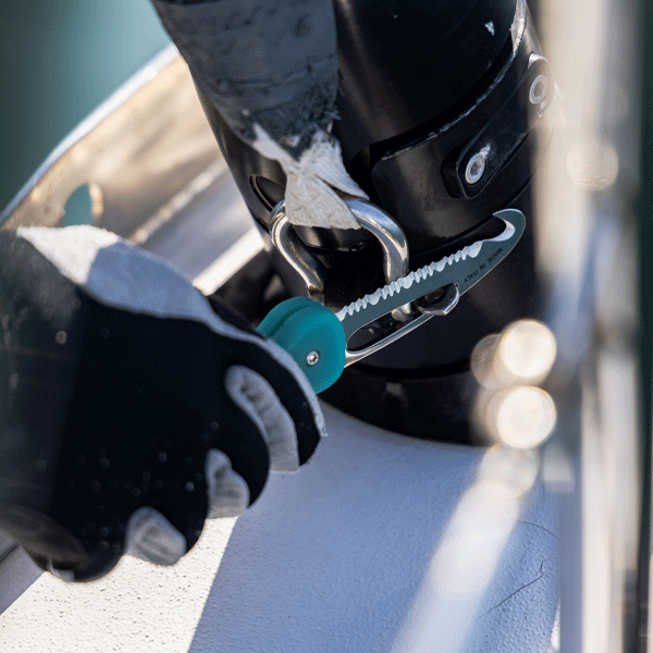 Boat safety knife being used as a shackle key on a sailing yacht