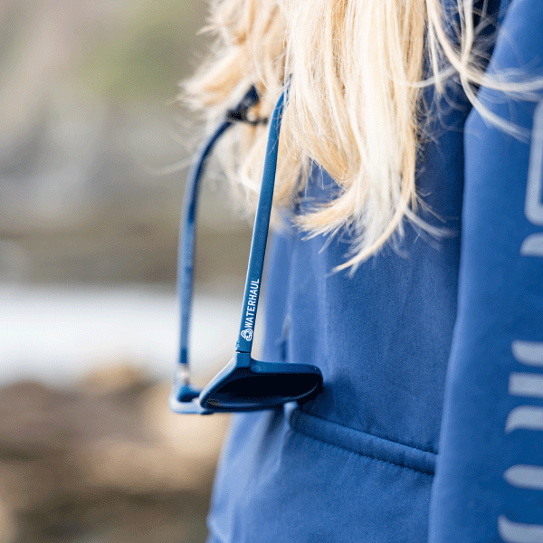Sunglasses hanging from glasses chain around a womans neck