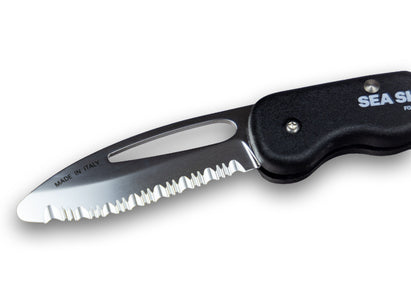 Folding knife with serrated blade and black handle on a white background