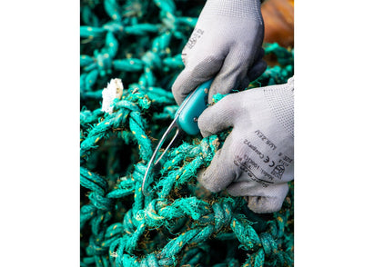 Serrated pocket knife with serrated handle  being used to cut through green fishing net.