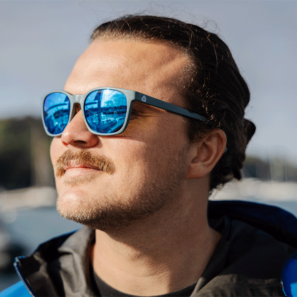 Man wearing blue reflective sunglasses outdoors